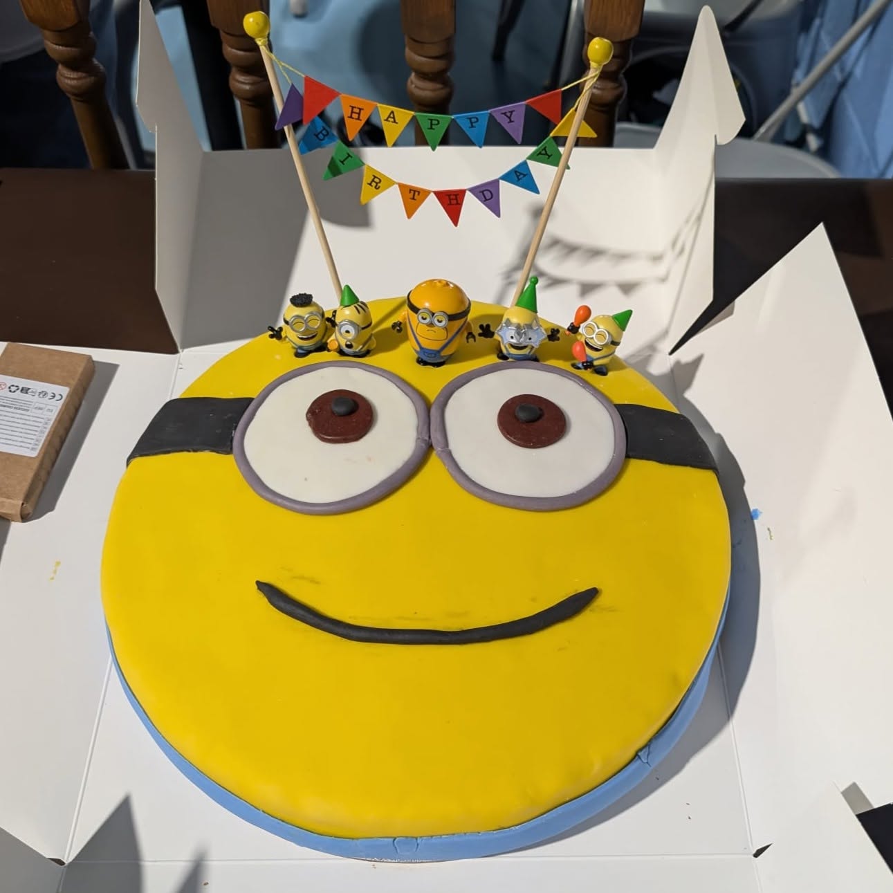 Round yellow minion-face cake with sugar paste decoration