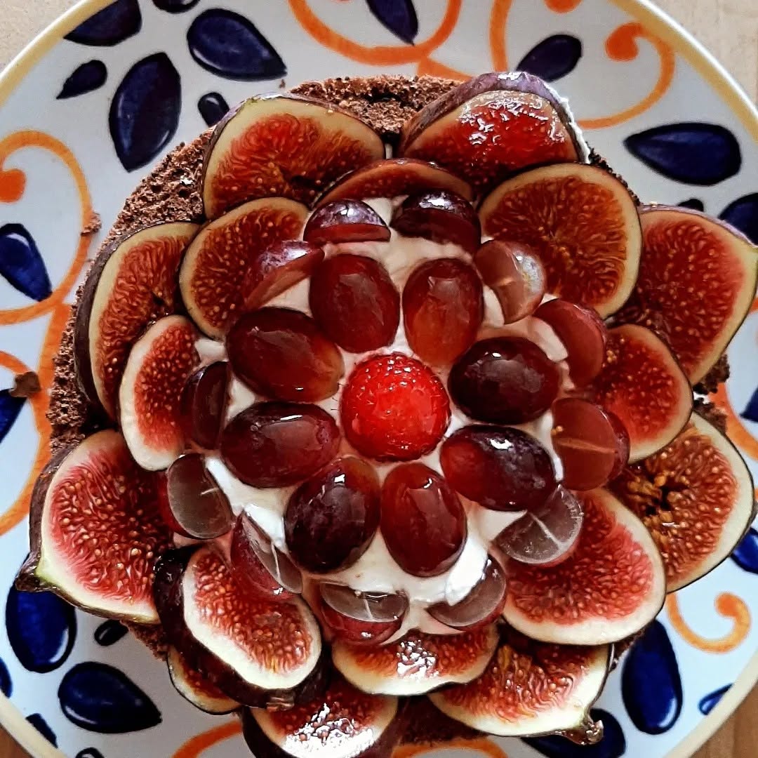 Chocolate charlotte topped with fresh figs and grapes