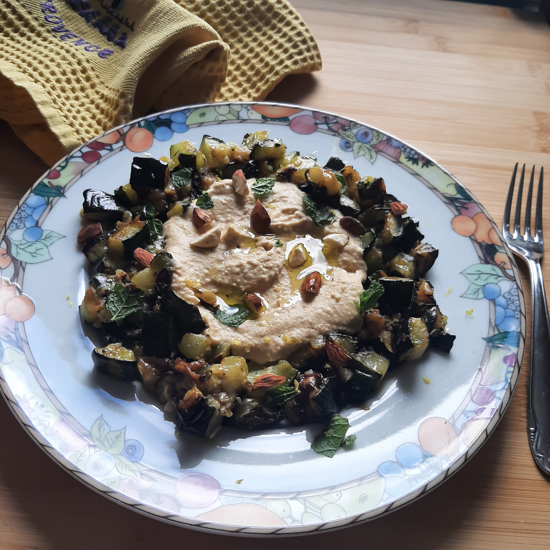 Roasted courgettes with hummus, almonds and mint