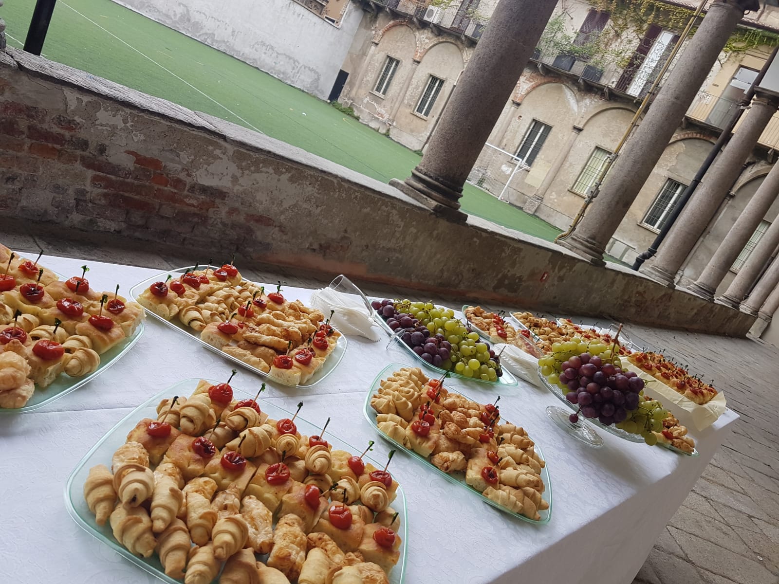 Buffet table laid out under a historic cloister