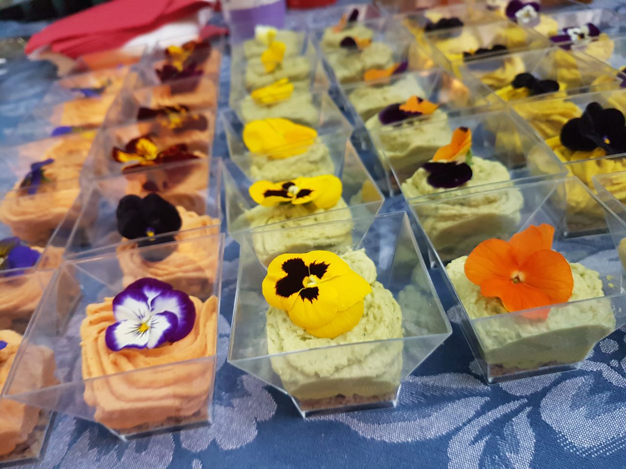 Small glasses of mousse topped with edible flowers